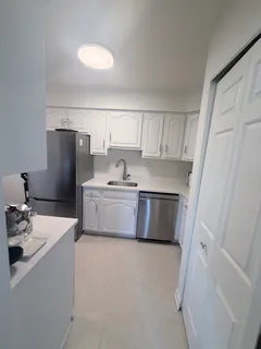 a utility room with cabinets washer and dryer