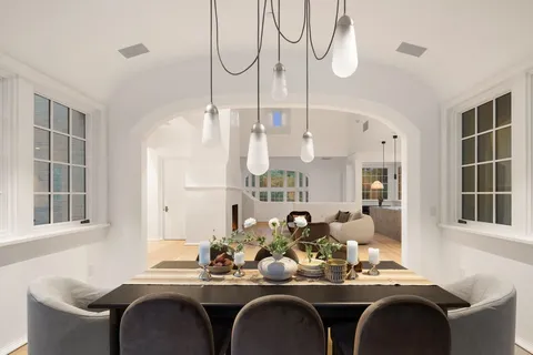 a dining room with furniture and a window