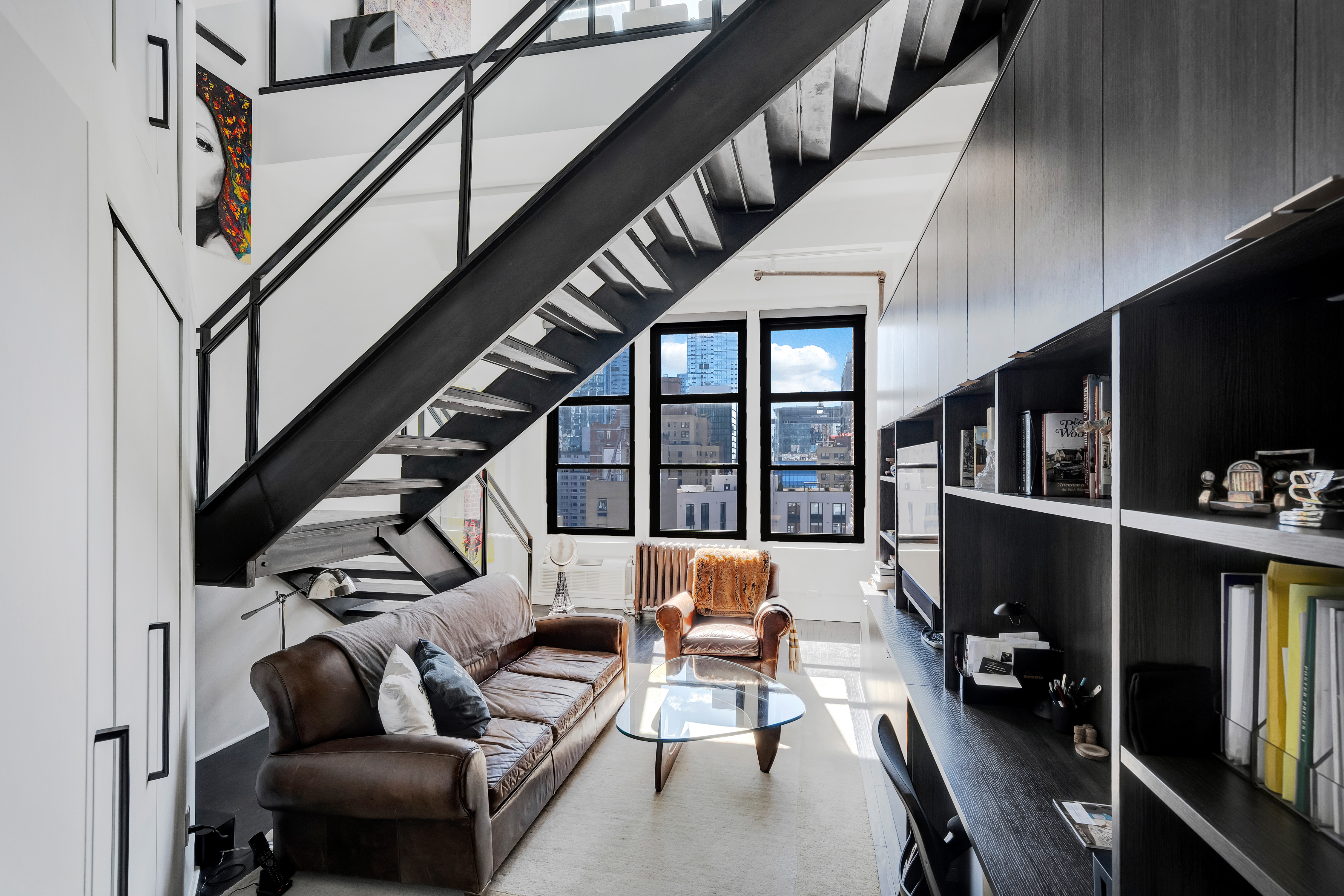 448 West 37th Street, Unit 11G/12G Manhattan, NY 10018 - Photo 10 of 17 a living room with furniture