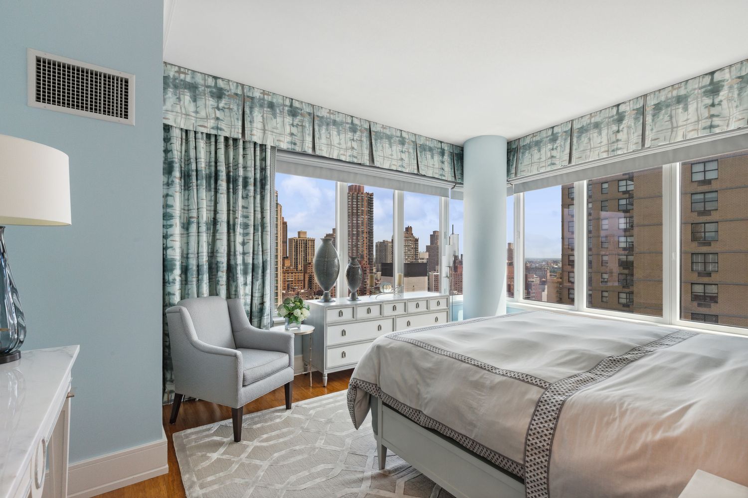 255 East 74th Street, Unit 20C Manhattan, NY 10021 - Photo 7 of 16 a bedroom with a bed and a large window