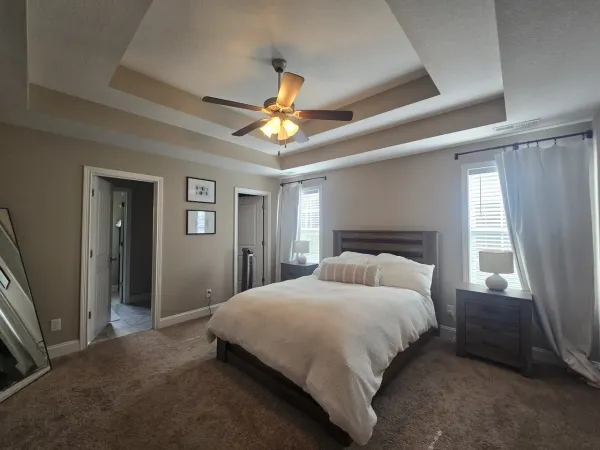 a bedroom with a bed and a chandelier