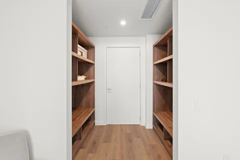 a view of hallway with stairs and wooden floor