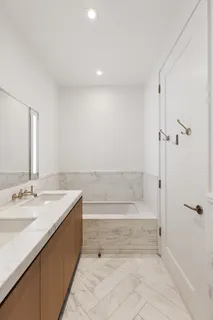 a spacious bathroom with a granite countertop sink a toilet and shower
