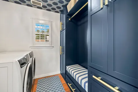 a bedroom with two beds and painting on the wall