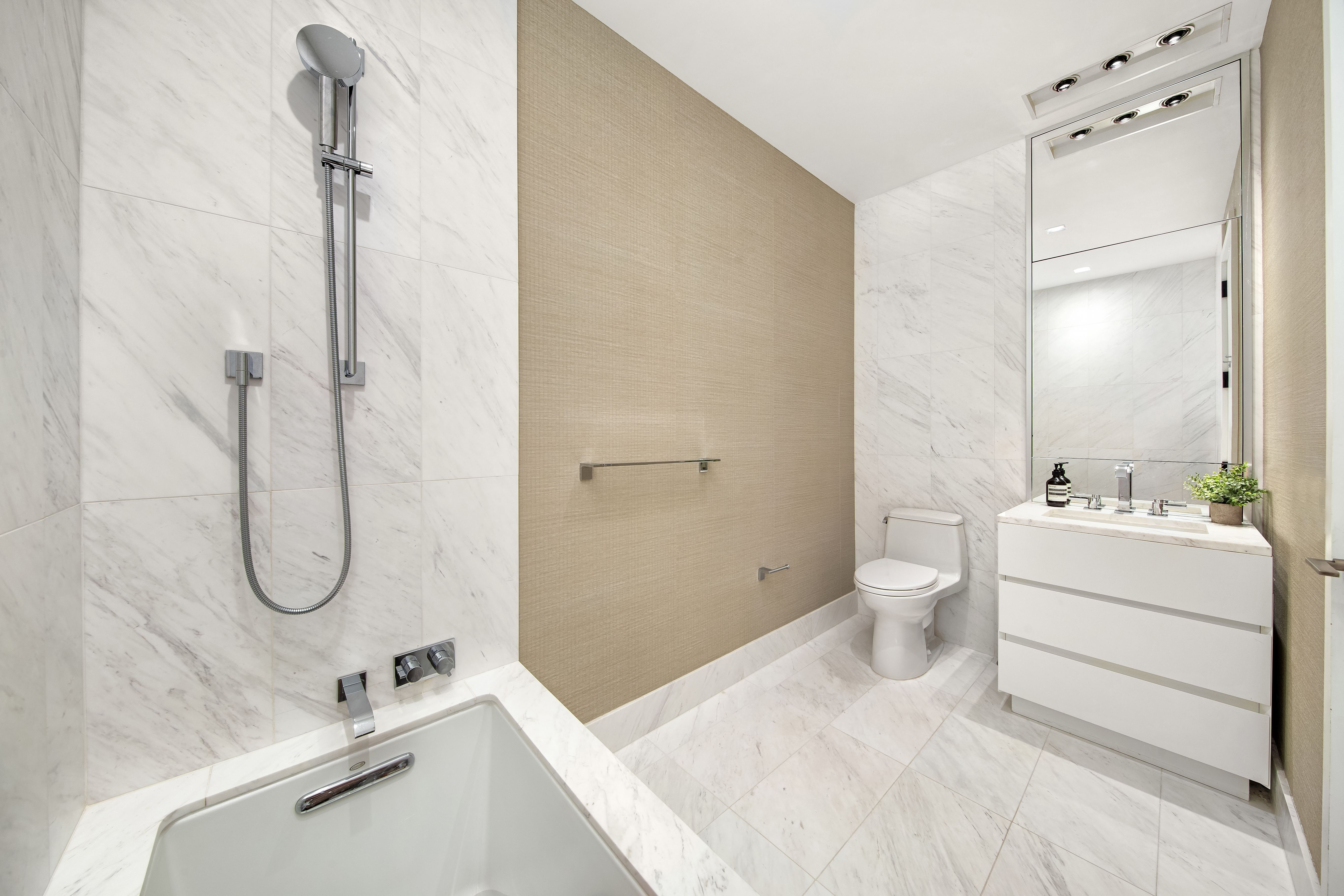 111 Murray Street, Unit 35A Manhattan, NY 10007 - Photo 16 of 38 a bathroom with a granite countertop sink a toilet and shower