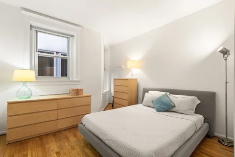 a bedroom with a bed and a dresser