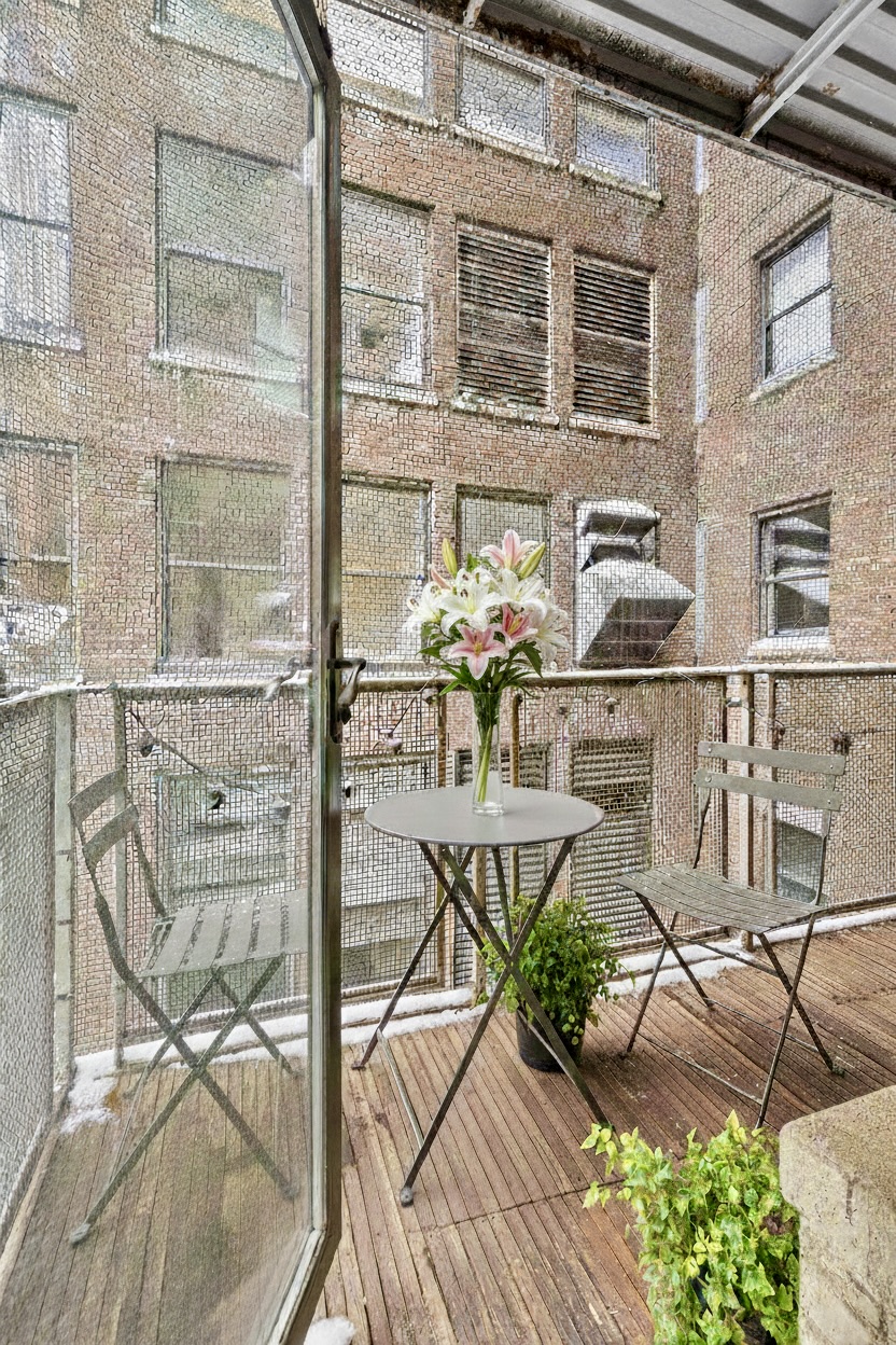 43-45 East 30th Street, Unit 5C Manhattan, NY 10016 - Photo 7 of 8 a balcony with table and chairs