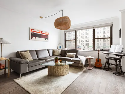 a living room with furniture a rug and a window