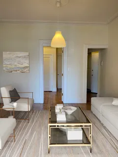 a living room with a couch and chandelier