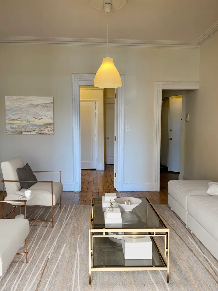 a living room with a couch and chandelier