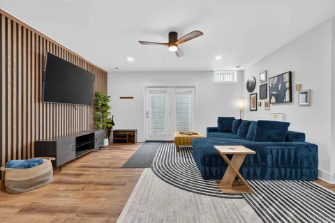 a living room with furniture a fireplace and a flat screen tv