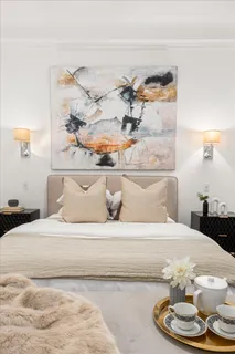 a bedroom with a bed and a lamp with the shoe rack