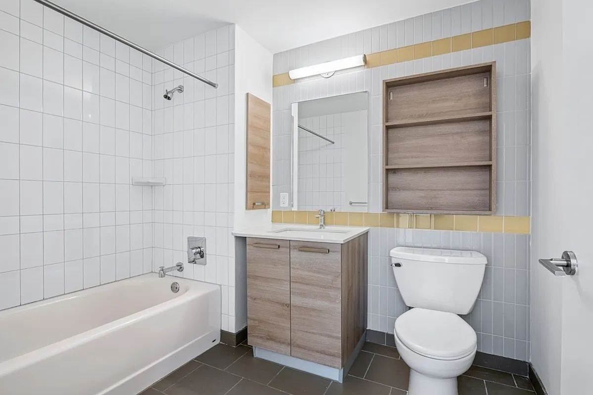 626 Flatbush Avenue, Unit 12D Brooklyn, NY 11225 - Photo 3 of 18 a bathroom with a sink a toilet and bathtub