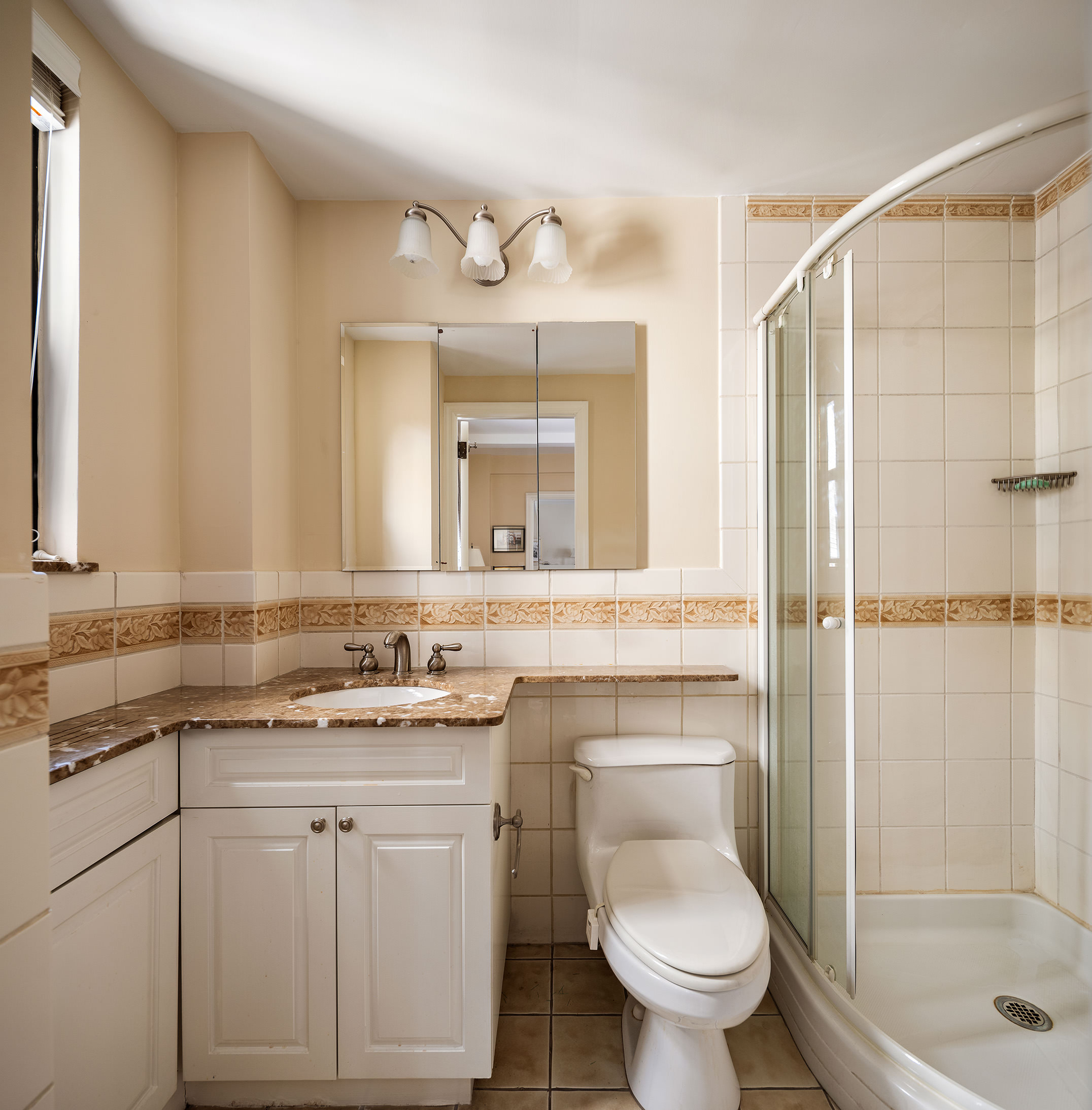 151 East 83rd Street, Unit 6D Manhattan, NY 10028 - Photo 10 of 14 a bathroom with a sink toilet and shower