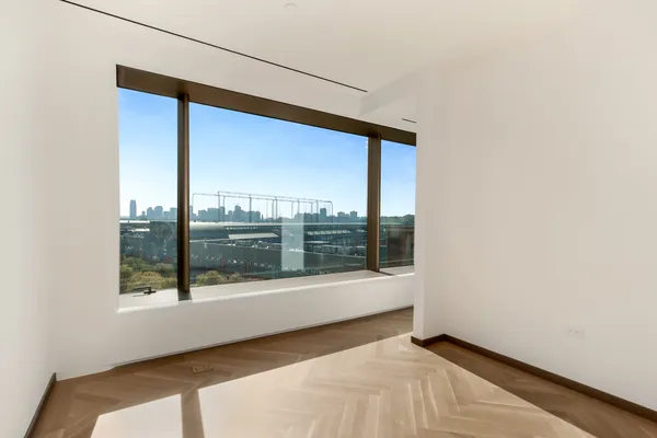 a bedroom with a large bed and a large window
