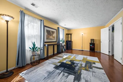 a living room with furniture fireplace and wooden floor