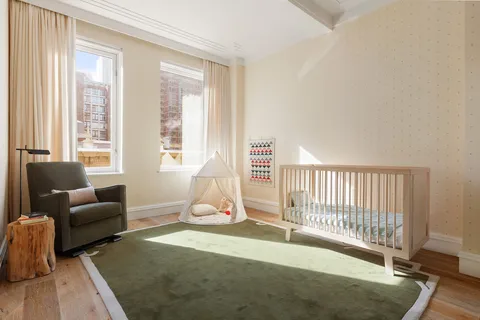 a bedroom with furniture and a window