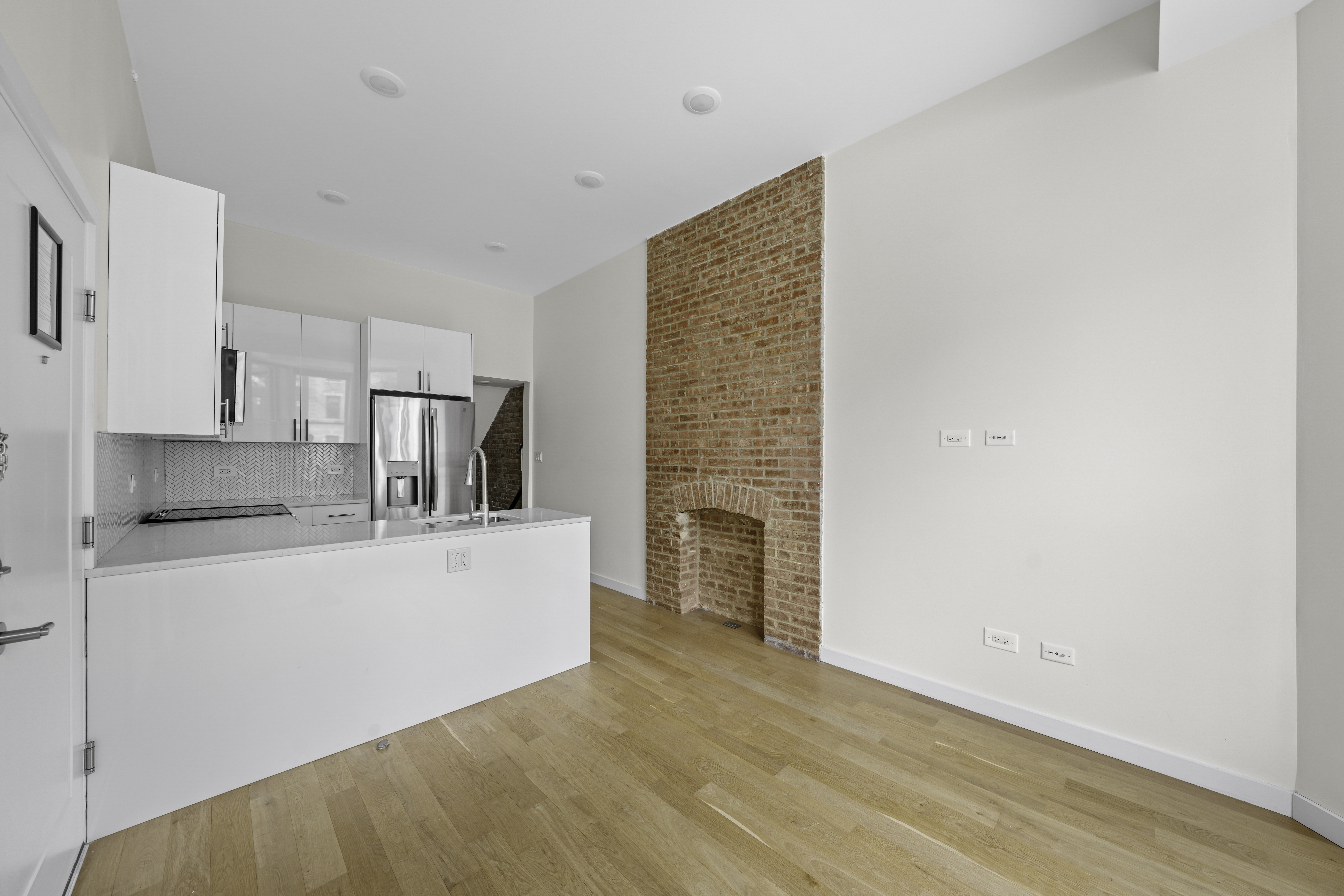 950 St Nicholas Avenue, Unit 1 Manhattan, NY 10032 - Photo 2 of 16 a view of kitchen with stainless steel appliances cabinets and wooden floor