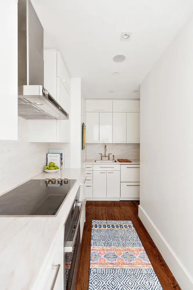 a kitchen with a white stove top oven and cabinets