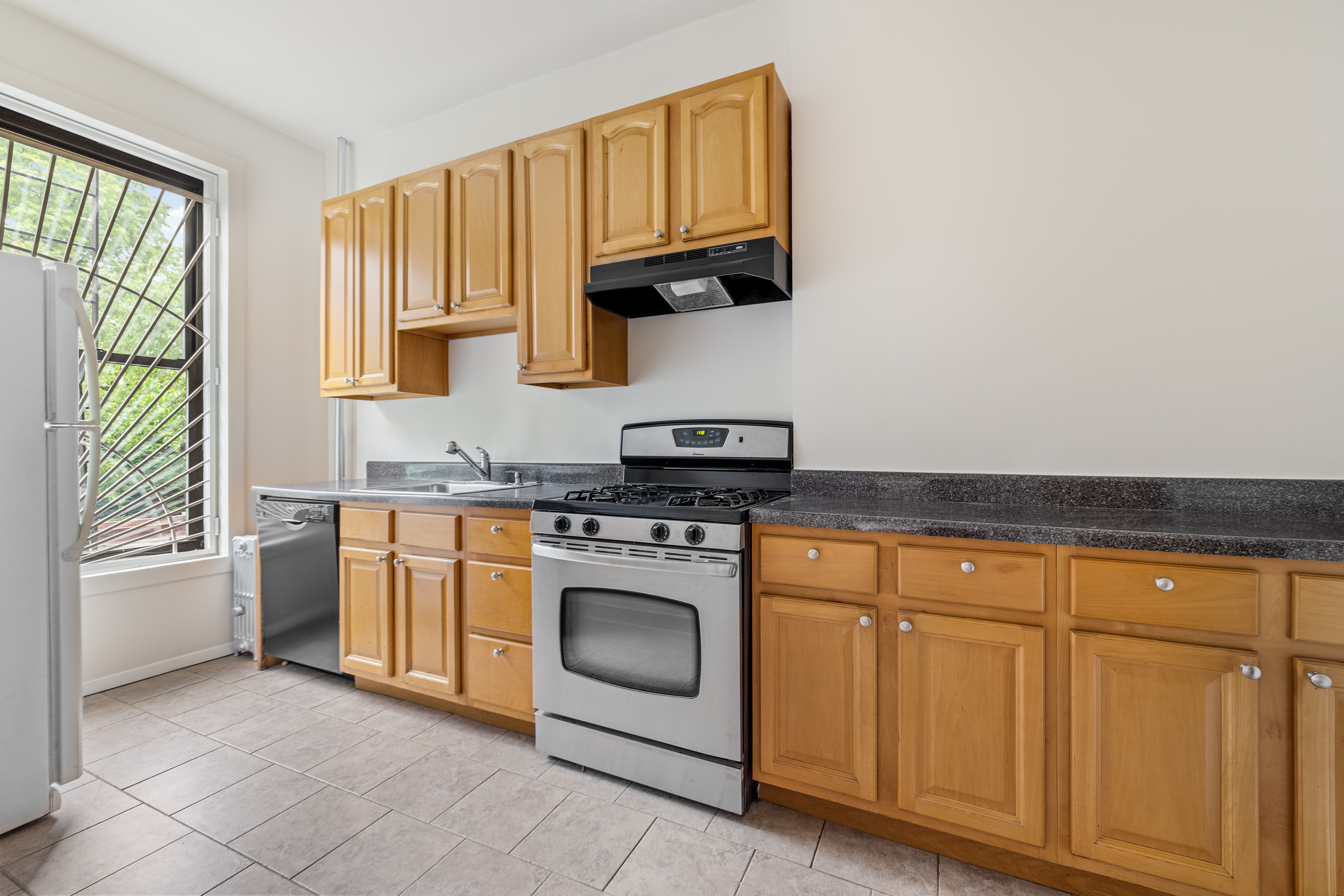 353 7th Avenue, Unit 1 Brooklyn, NY 11215 - Photo 6 of 8 a kitchen with granite countertop cabinets stainless steel appliances and a sink