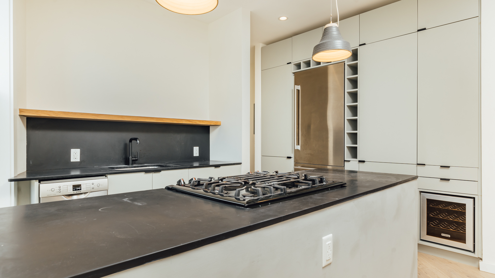 880 Woodward Avenue, Unit 2 Queens, NY 11385 - Photo 6 of 18 a kitchen with a stove and a refrigerator