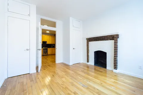 a view of an empty room with a fireplace