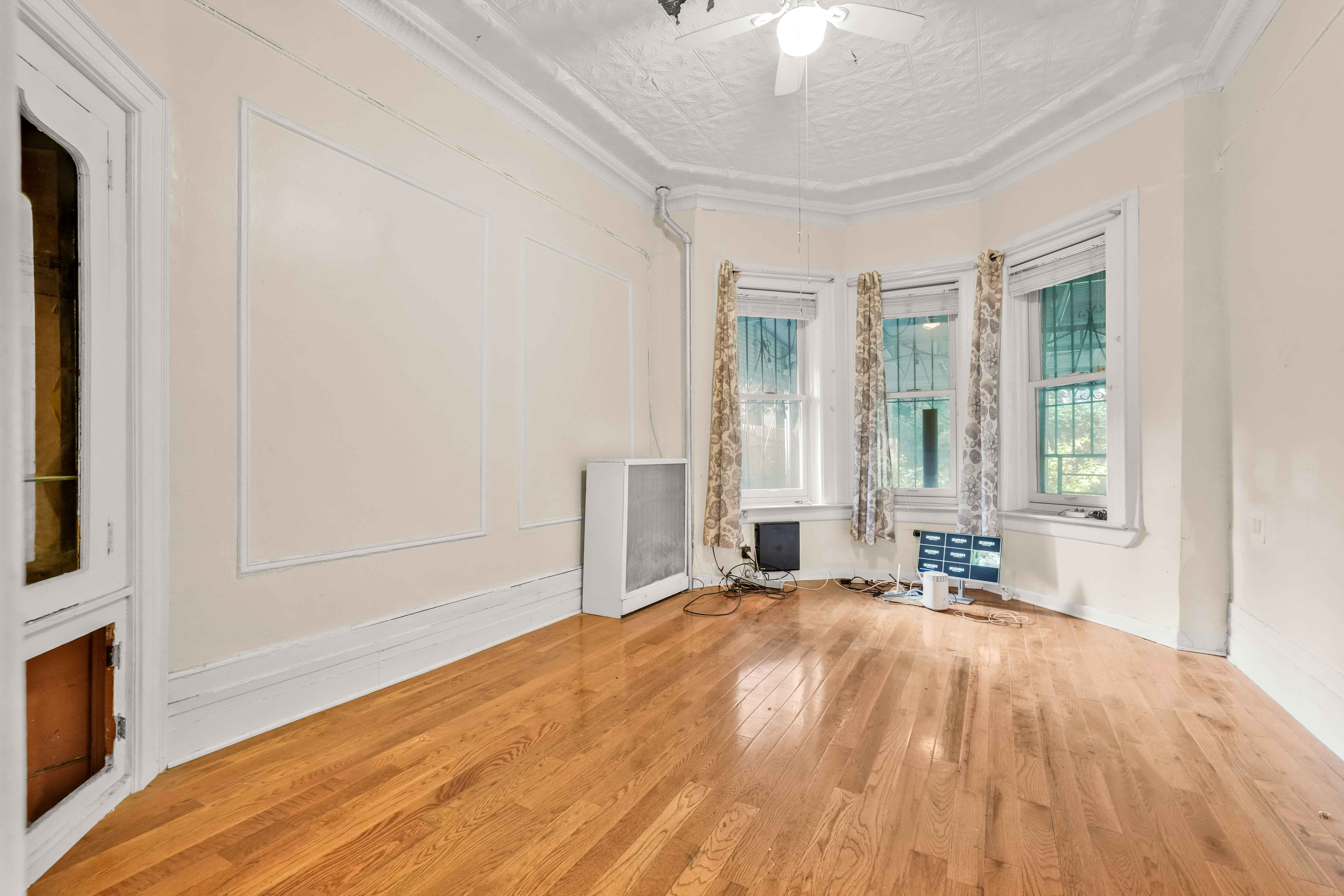 278 Lefferts Avenue Brooklyn, NY 11225 - Photo 36 of 56 a spacious bedroom with a bed and a window