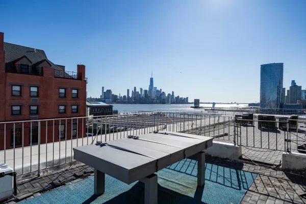 a view of a roof deck with furniture