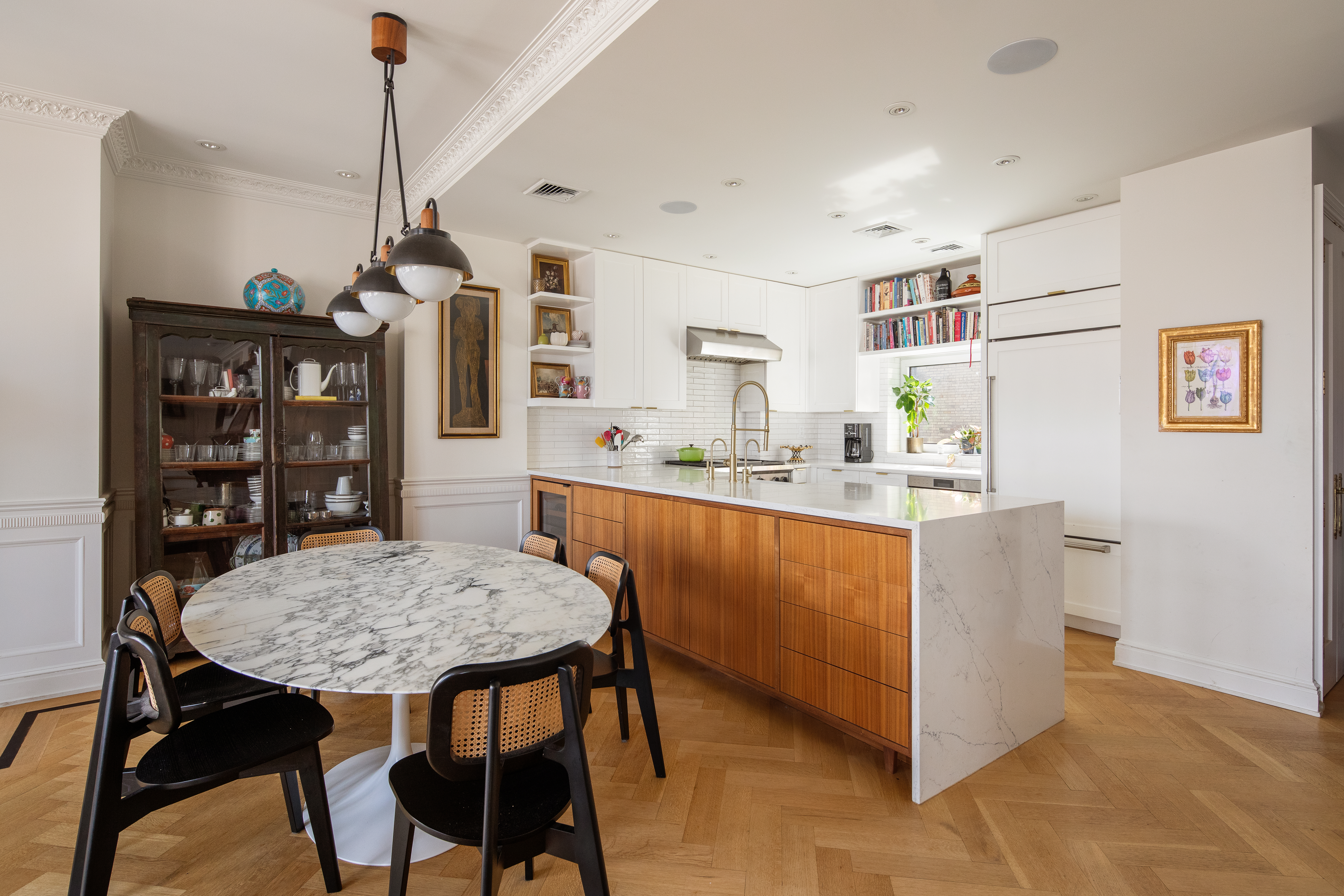 309 West 86th Street, Unit PH Manhattan, NY 10024 - Photo 5 of 16 a kitchen with stainless steel appliances granite countertop a dining table chairs and a refrigerator