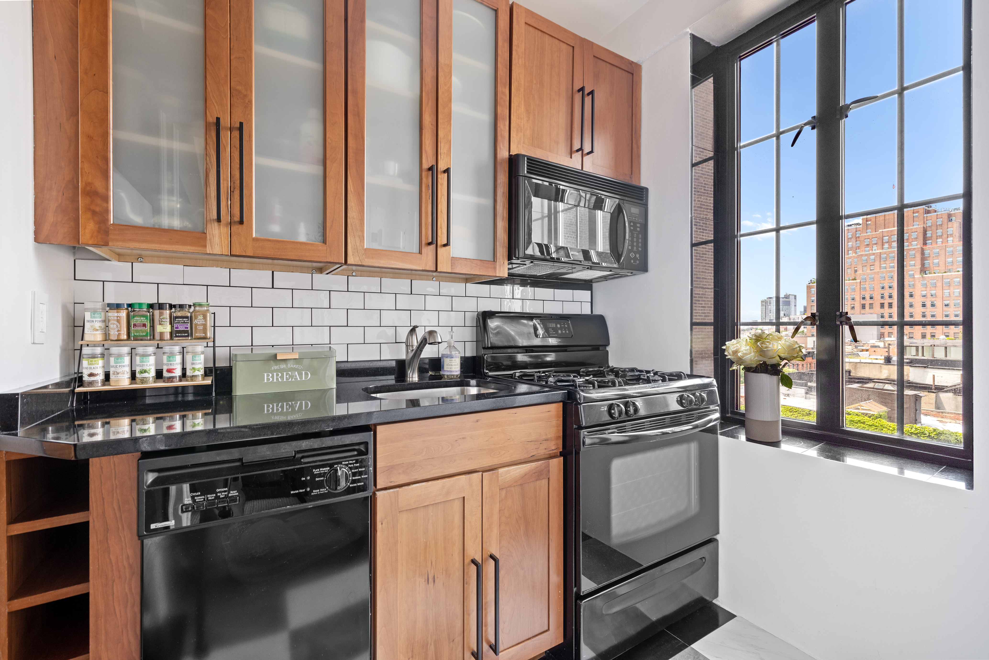 201 West 16th Street, Unit 8F Manhattan, NY 10011 - Photo 4 of 11 a kitchen with stainless steel appliances granite countertop a stove and a refrigerator