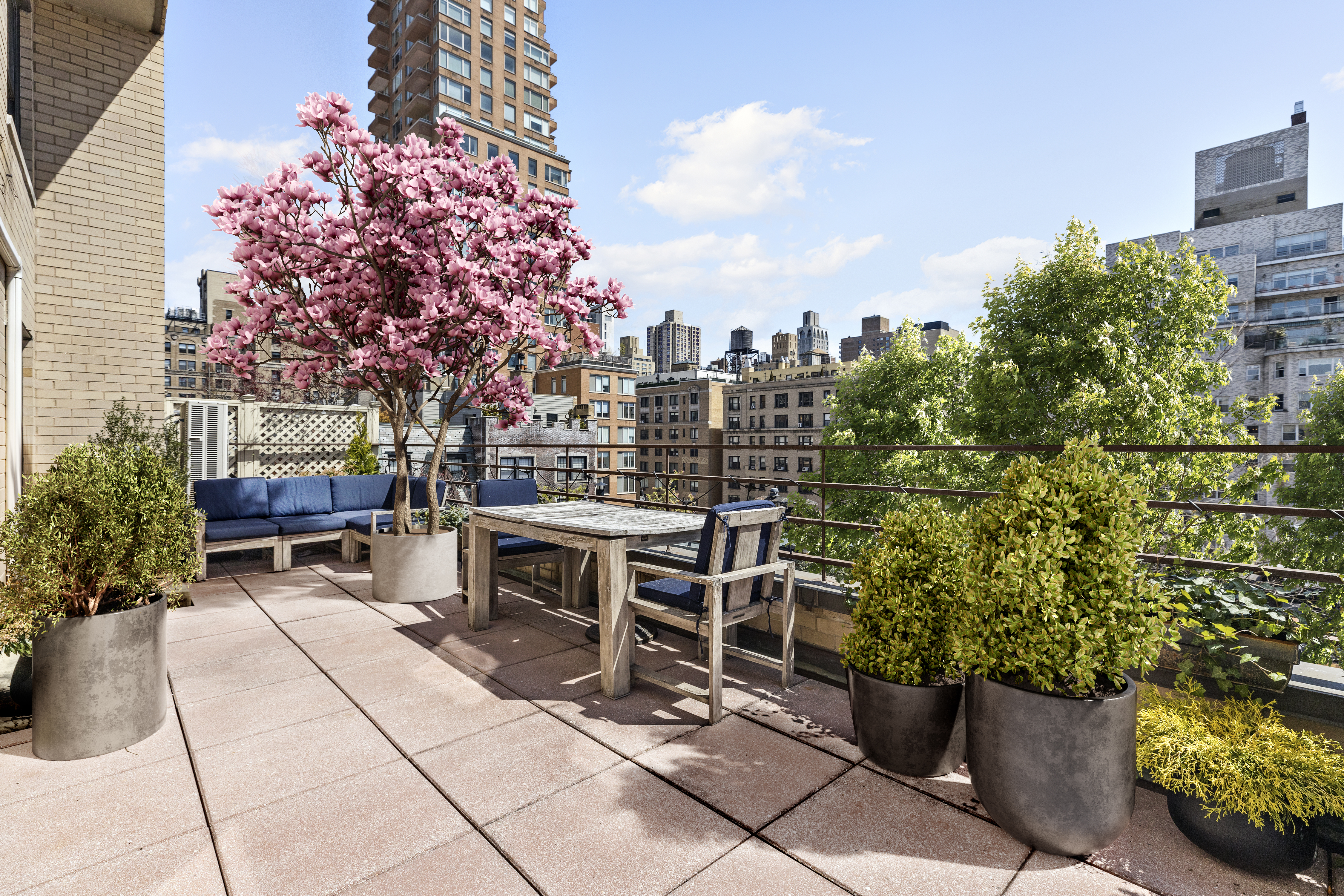 a view of a patio with a table and chairs and potted plants