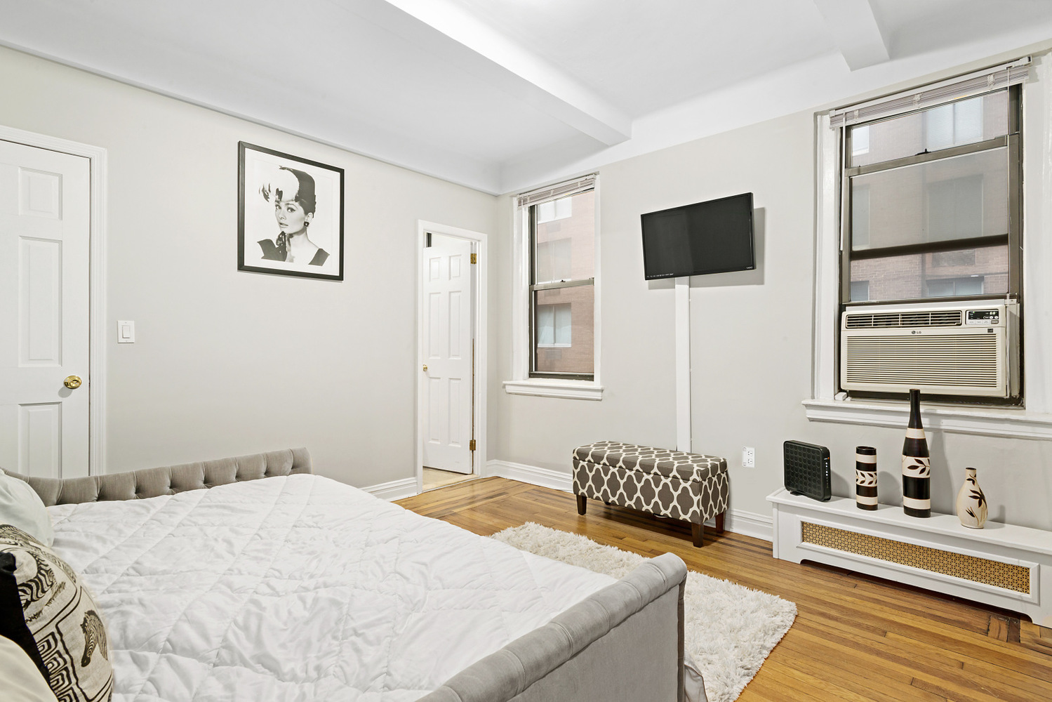 a bedroom with a large bed and flat screen tv
