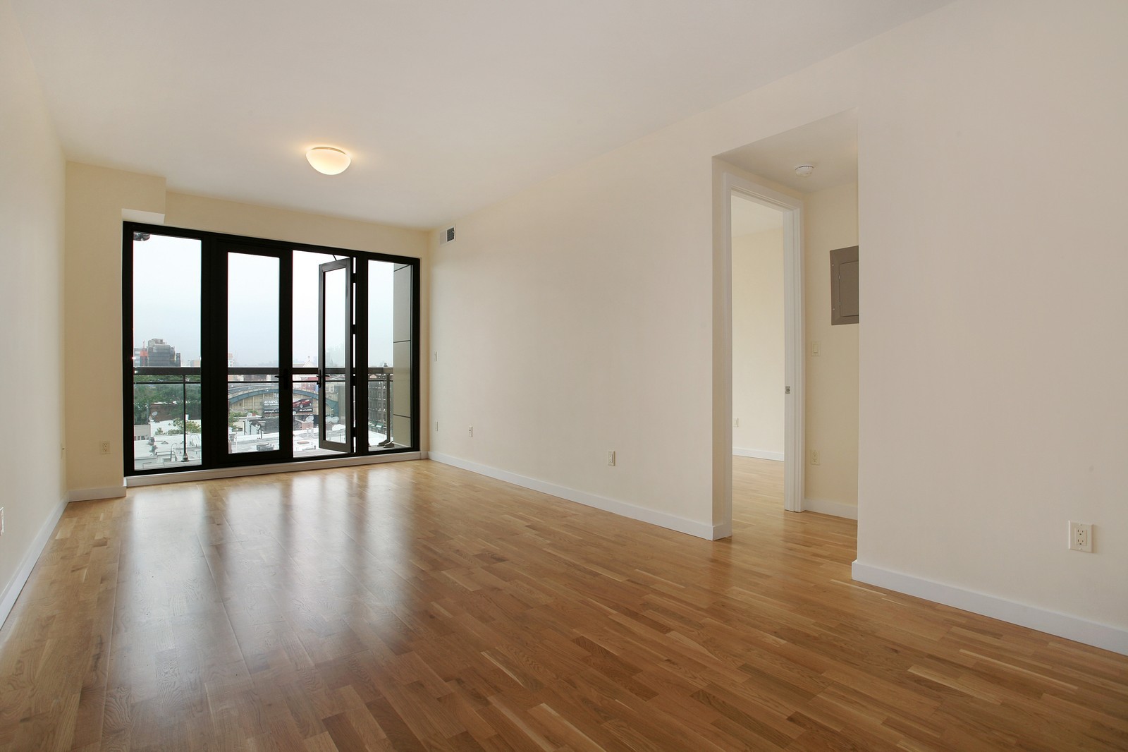 wooden floor in an empty room with a window