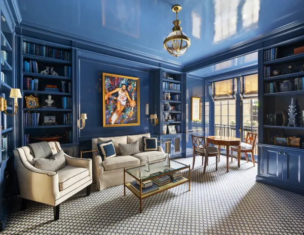a living room with furniture and a book shelf