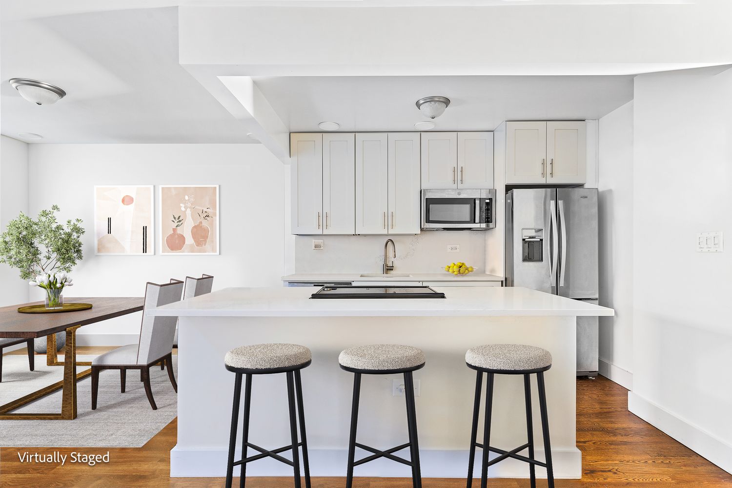 a kitchen with stainless steel appliances a table chairs and a refrigerator