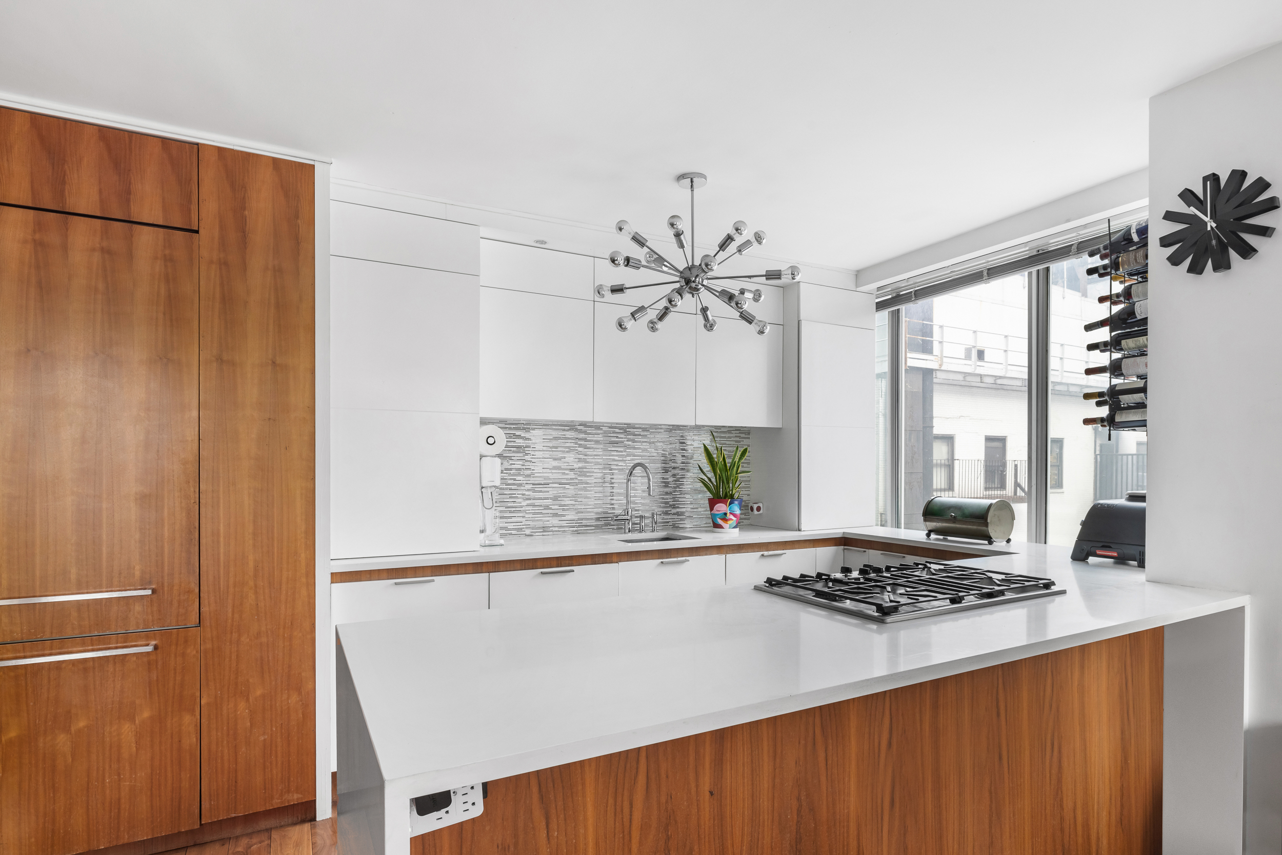 61 West 62nd Street, Unit 16D Manhattan, NY 10023 - Photo 4 of 11 a kitchen with a table and a stove top oven