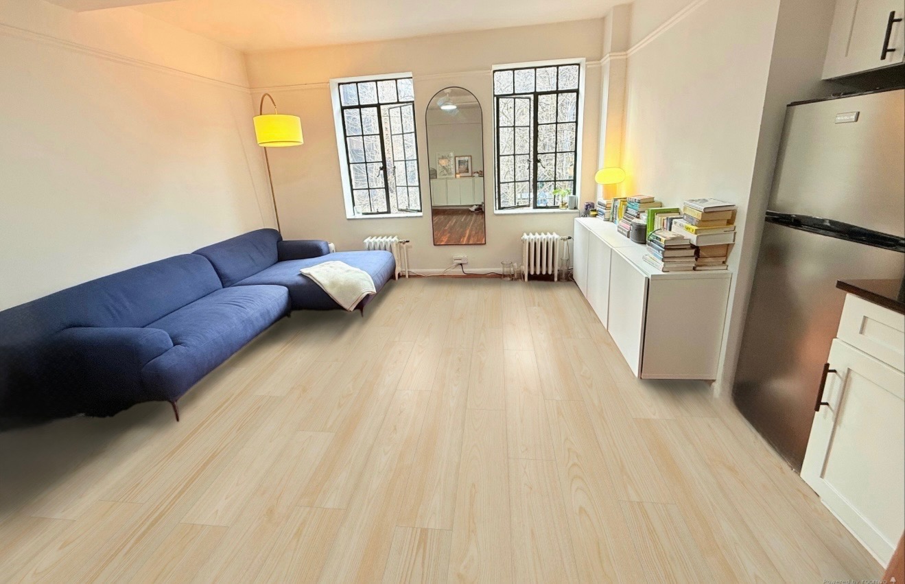 45 Tudor City Place, Unit 418 Manhattan, NY 10017 - Photo 1 of 11 a living room with a couch and a table