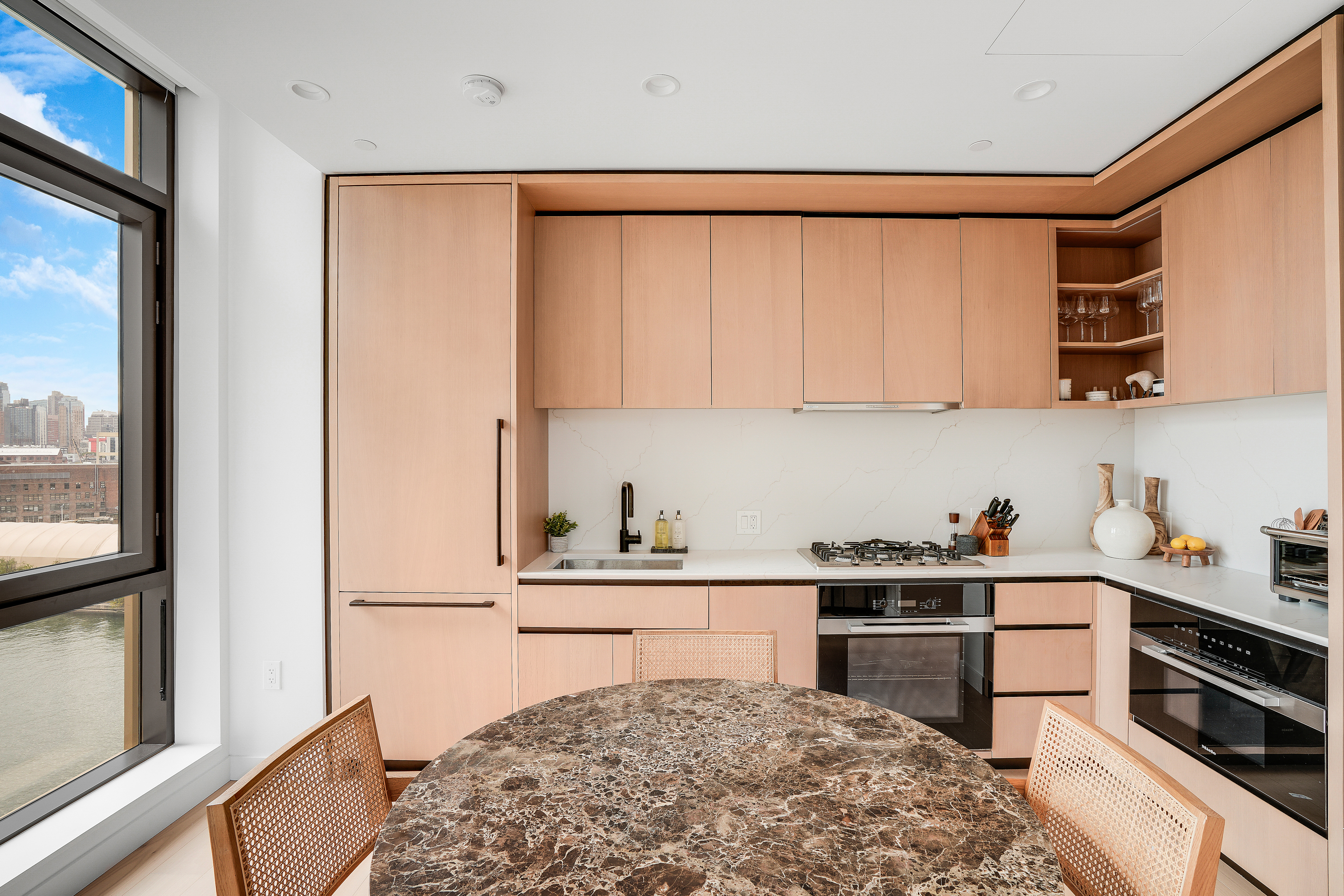 480 Kent Avenue, Unit 9A Brooklyn, NY 11249 - Photo 5 of 33 a kitchen with stainless steel appliances granite countertop a refrigerator sink and cabinets