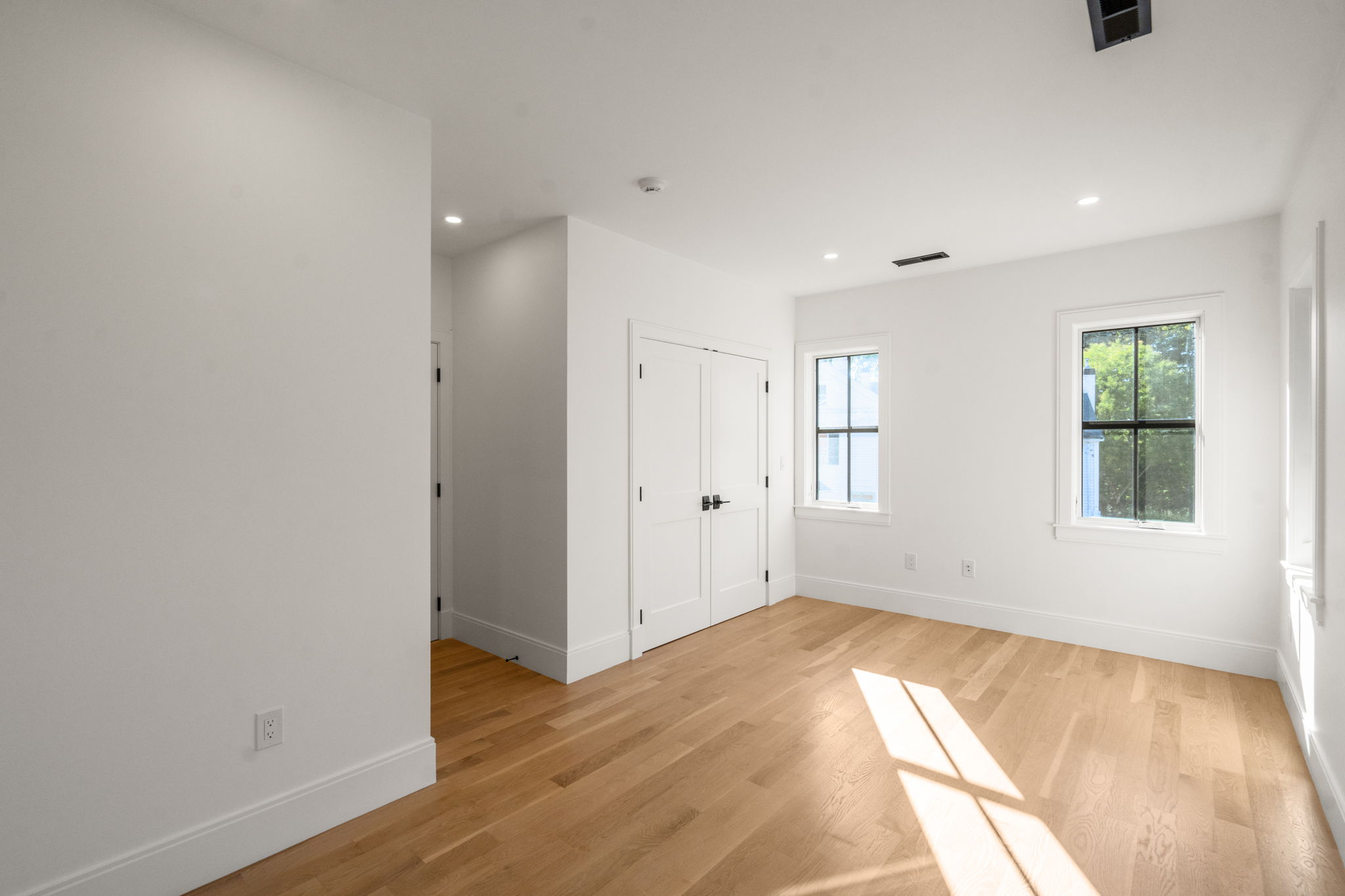 20 Oakland Street Wellesley, MA 02481 - Photo 22 of 30 an empty room with wooden floor and windows