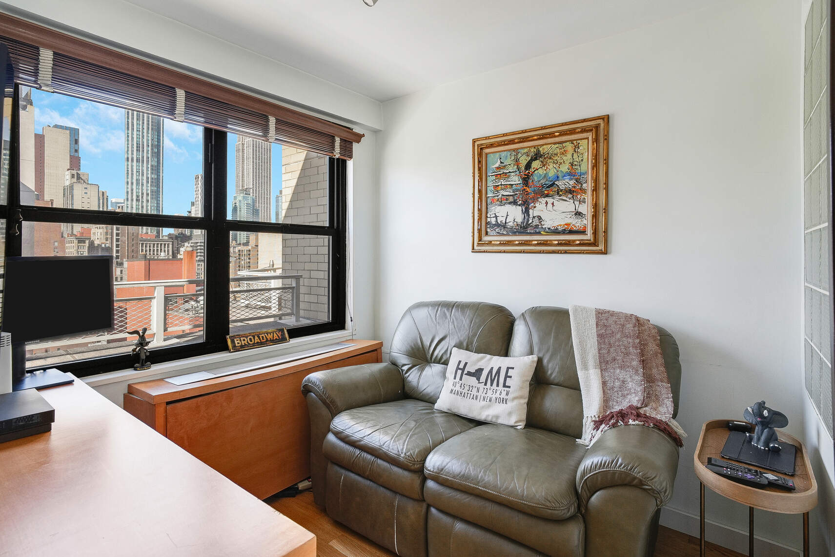 201 East 28th Street, Unit 21BC Manhattan, NY 10016 - Photo 12 of 24 a living room with furniture and a flat screen tv