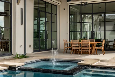a swimming pool with outdoor seating