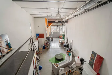 a view of entryway with workspace and livingroom view