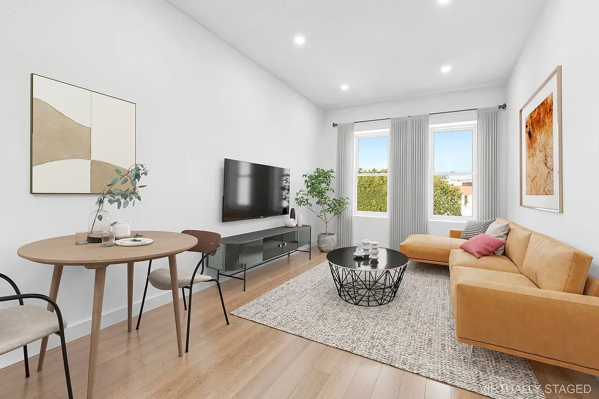 a living room with furniture a flat screen tv and a large window