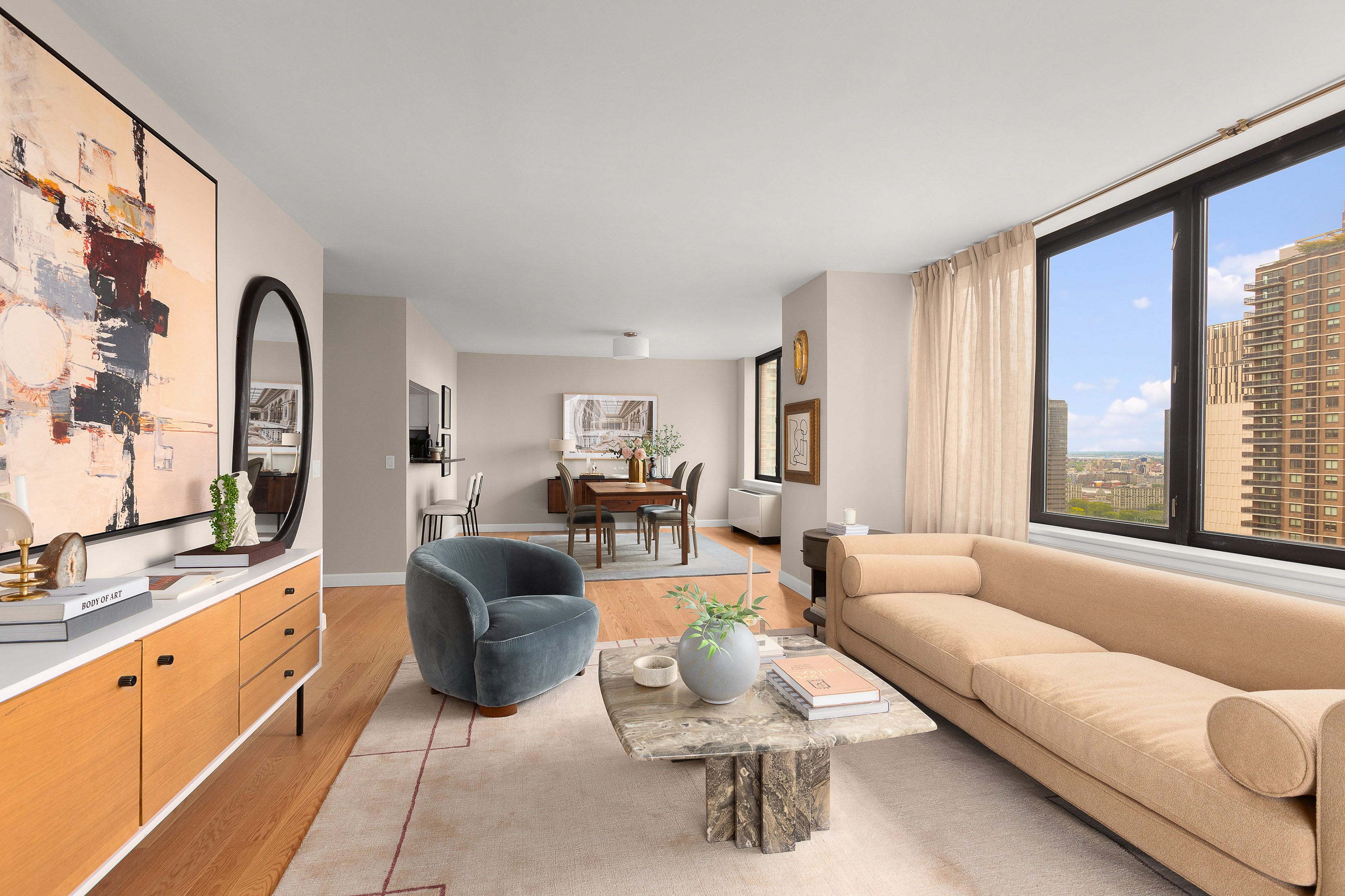 a living room with furniture and large windows