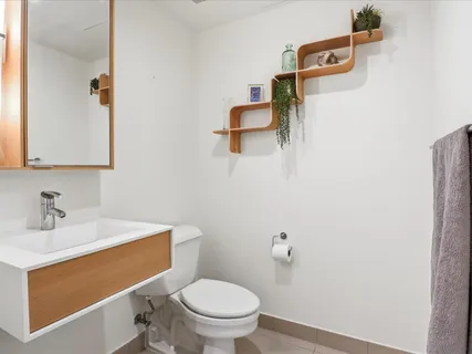 a bathroom with a sink a toilet and mirror