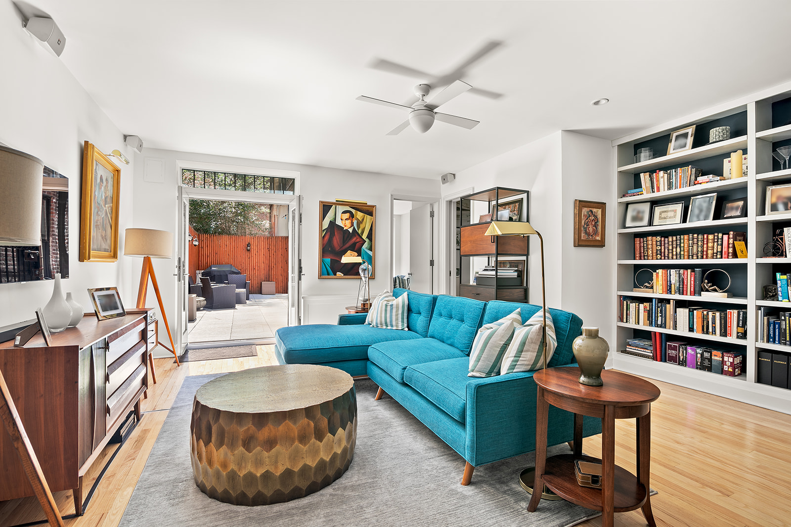 24 West 70th Street, Unit 1 Manhattan, NY 10023 - Photo 5 of 11 a living room with furniture and a book shelf
