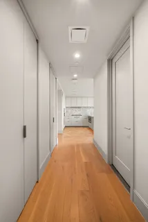a view of a big room with wooden floor and windows