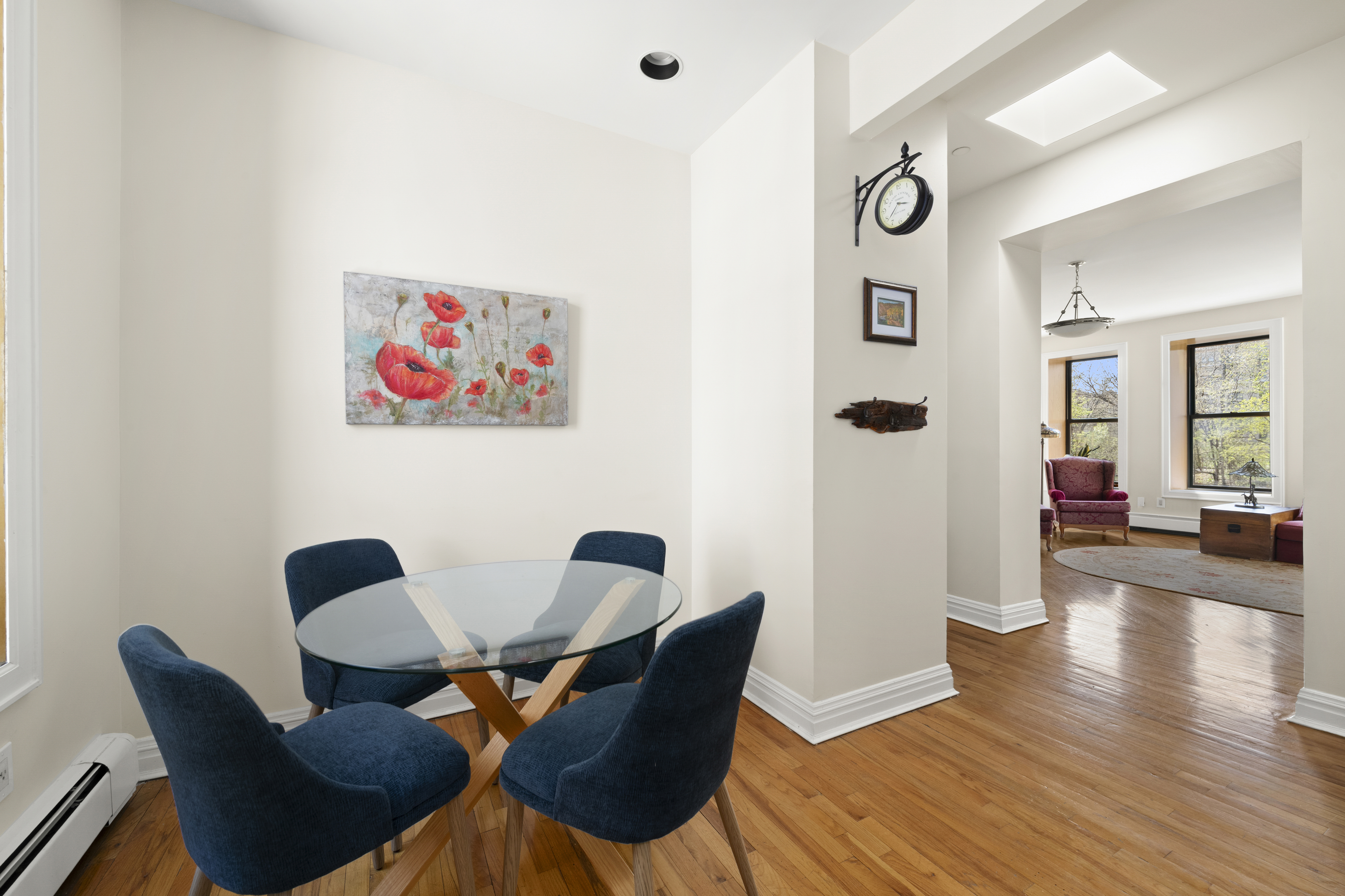 370 St Nicholas Avenue, Unit PH5B Manhattan, NY 10027 - Photo 3 of 12 a view of a dining room with furniture and wooden floor