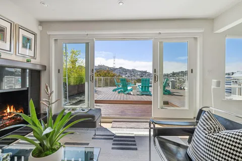 a living room with furniture a window and a potted plant