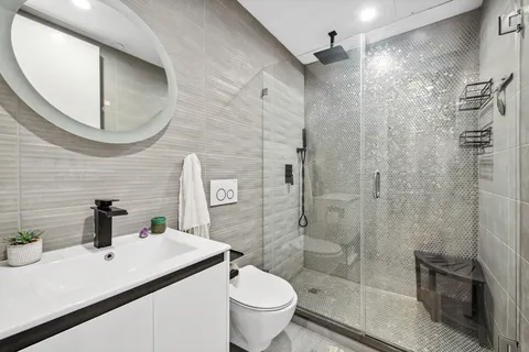 a bathroom with a sink a toilet and a mirror